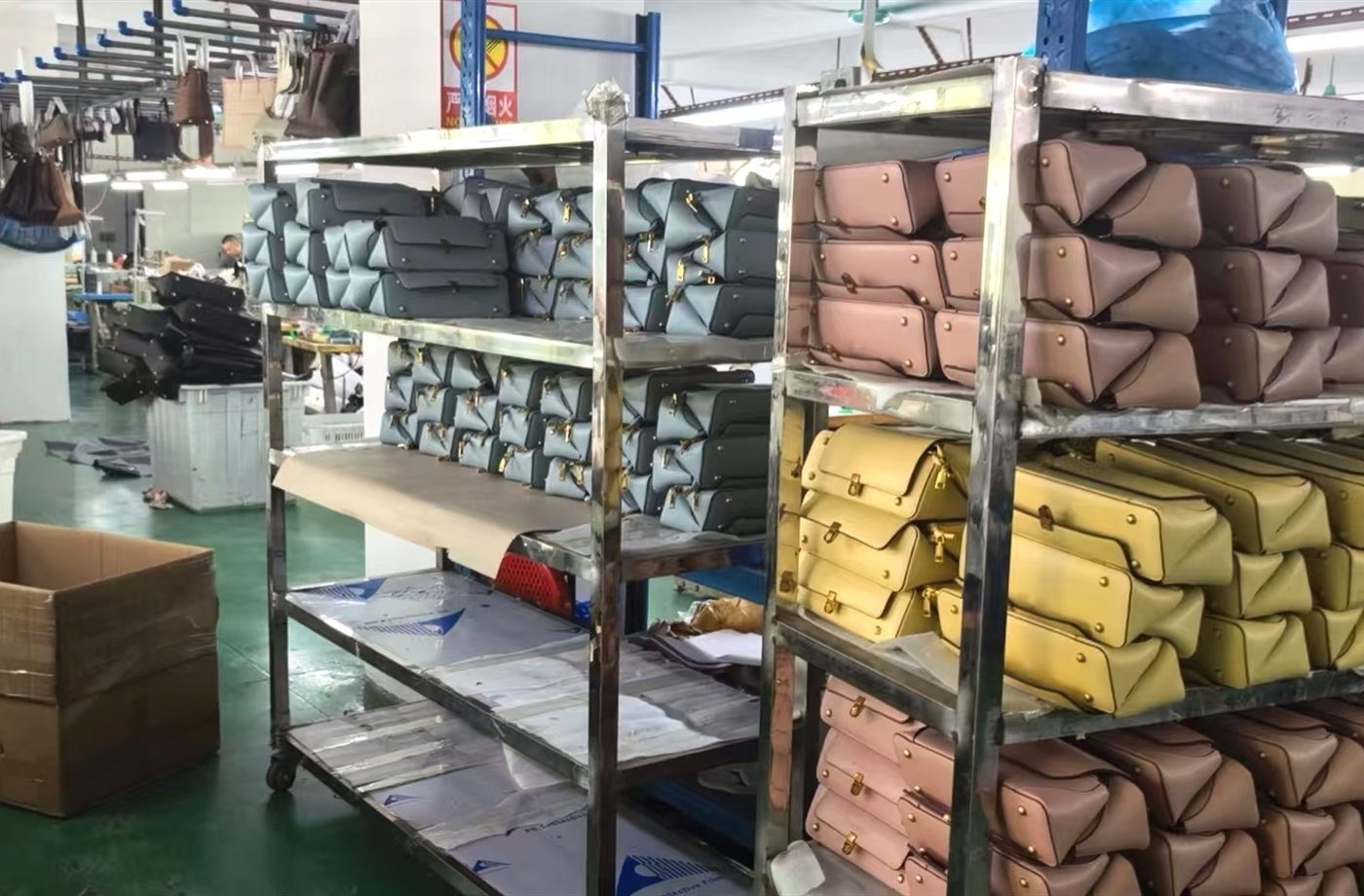 Factory racks filled with finished handbags in multiple colors