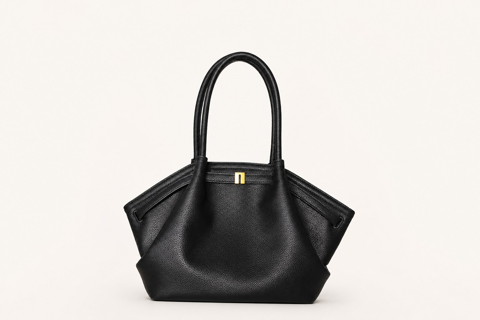 Black structured handbag on warm studio background
