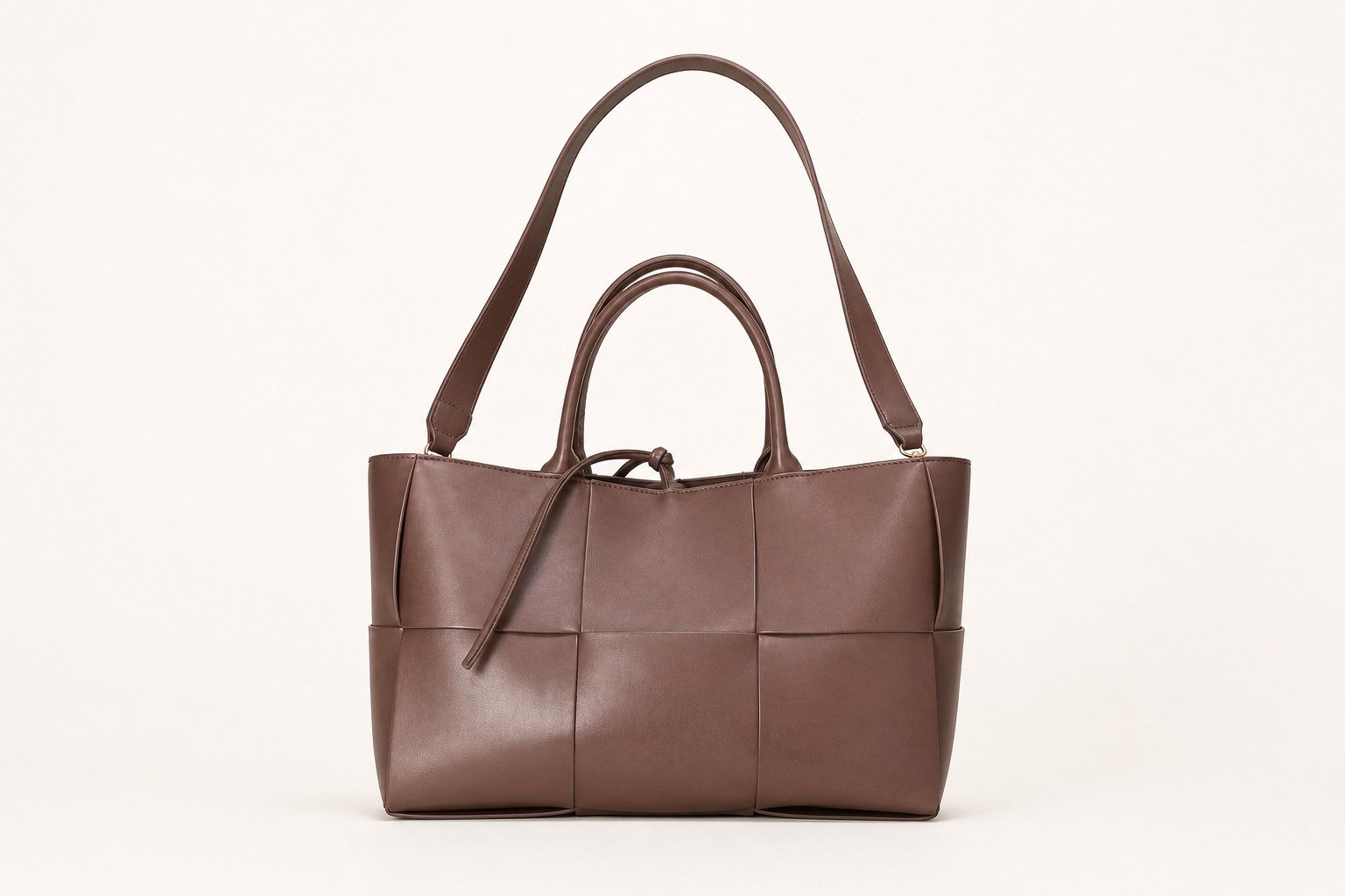 Brown commuter tote bag on warm studio background