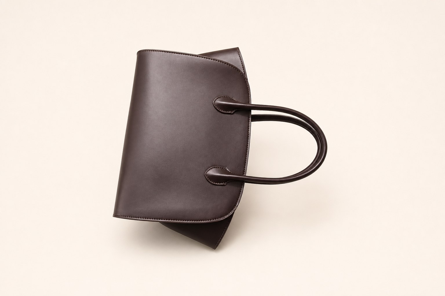 Dark office tote bag on warm studio background