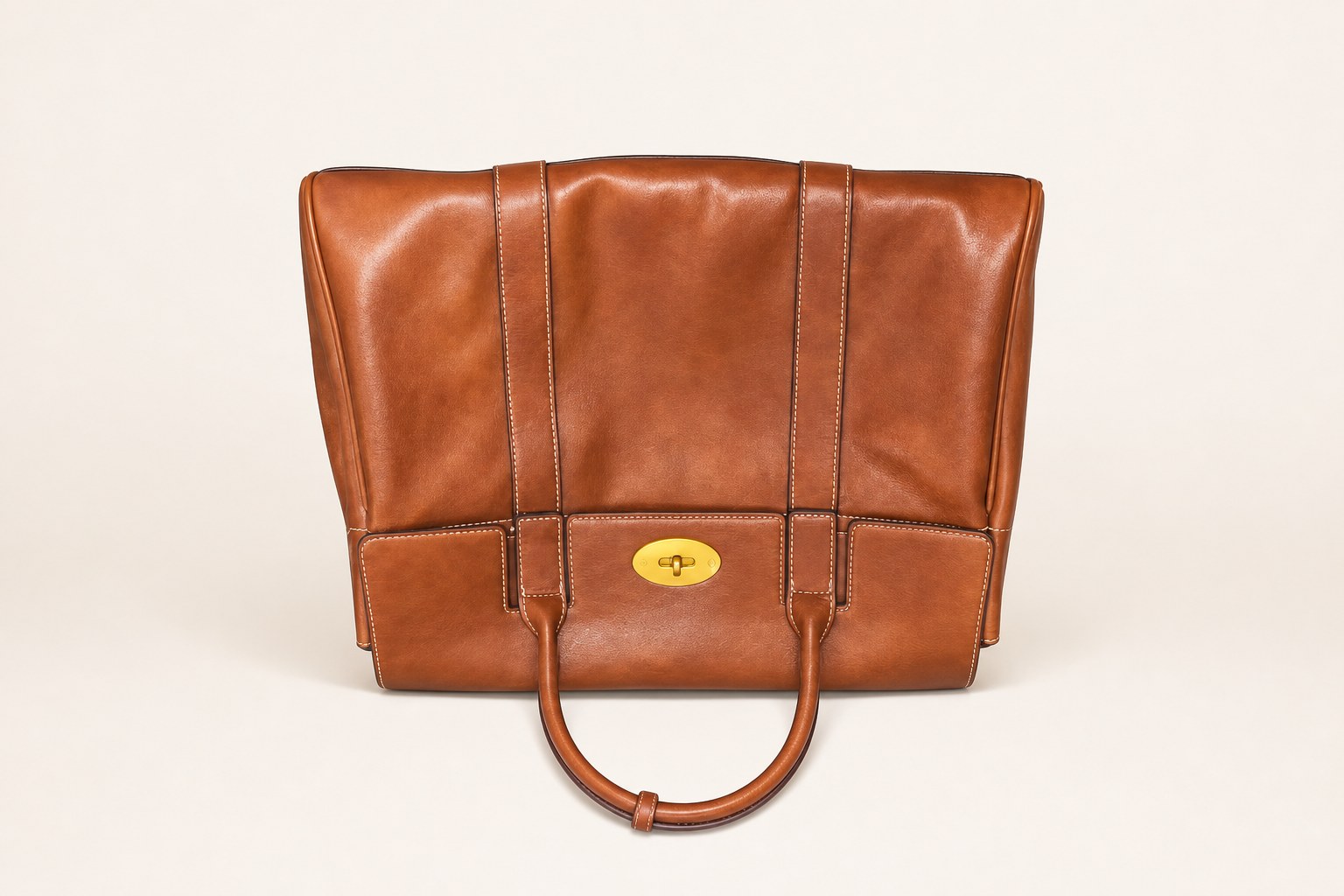 Tan structured office tote bag on studio background